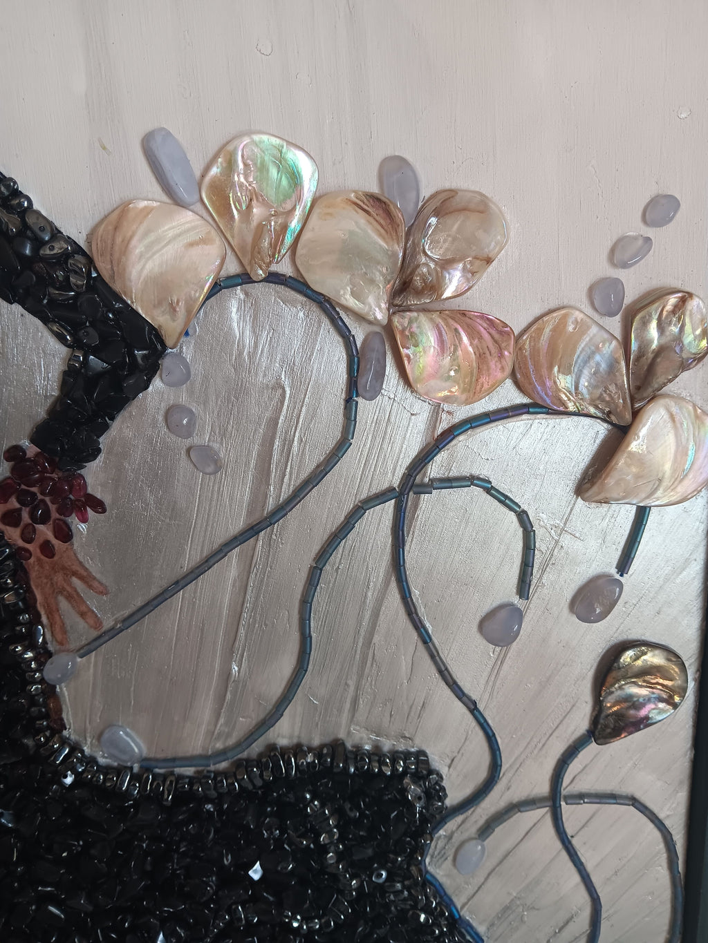 Close-up of a decorative headpiece with shell-like embellishments on a plain background