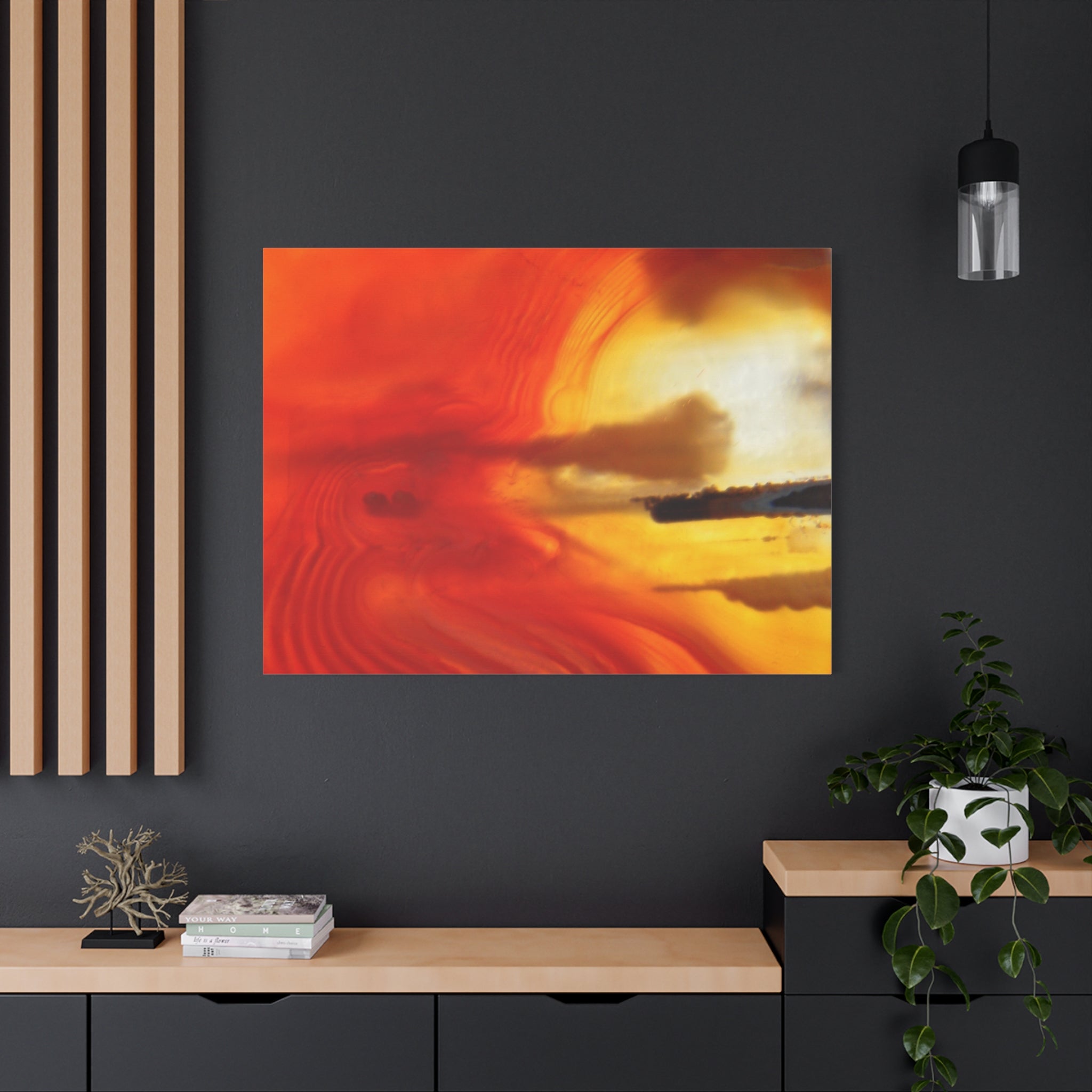Abstract artwork with warm colors on a dark wall above a wooden shelf.