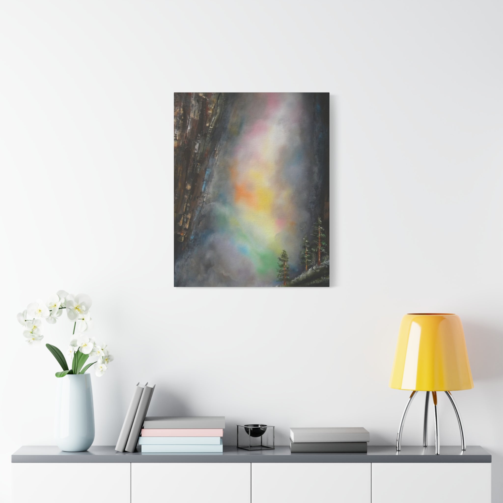A canvas print featuring a mystical waterfall with a colorful, abstract mist in the foreground and a dark, rugged cliff in the background.