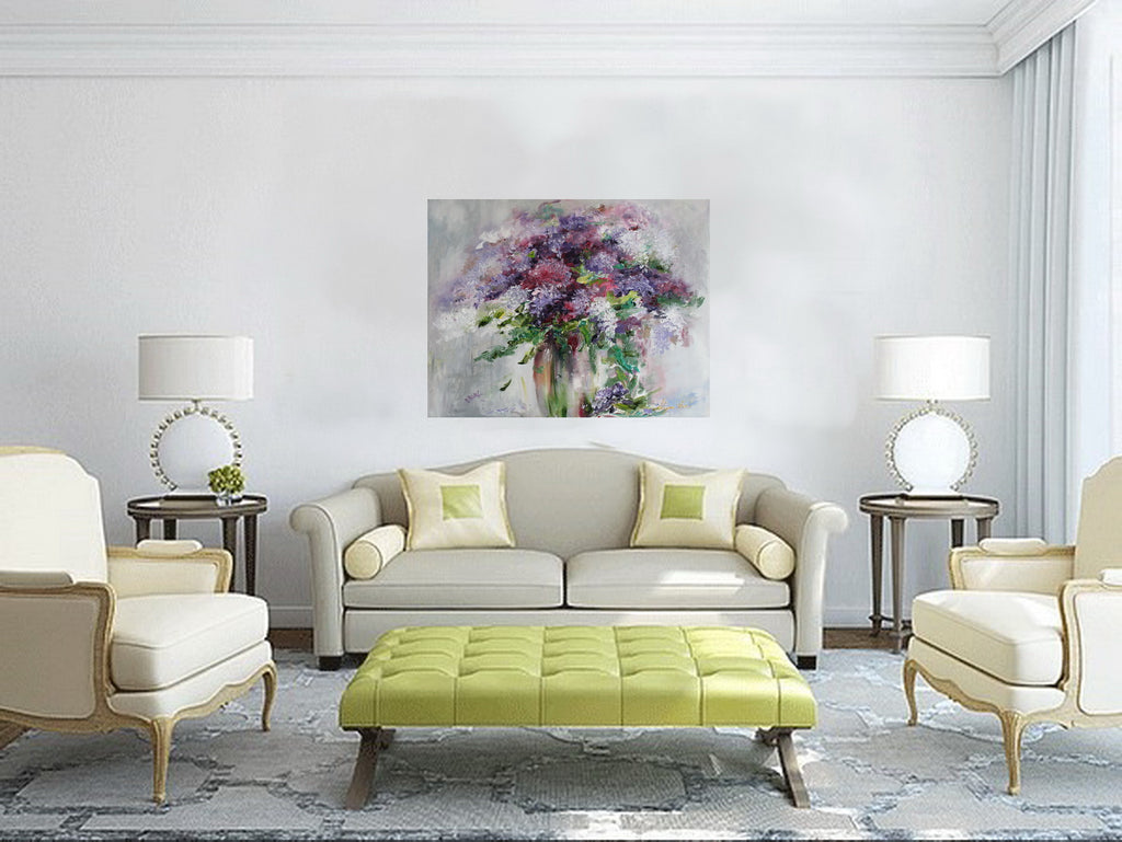 Modern living room with a gray sofa, green ottoman, and floral painting on the wall.
