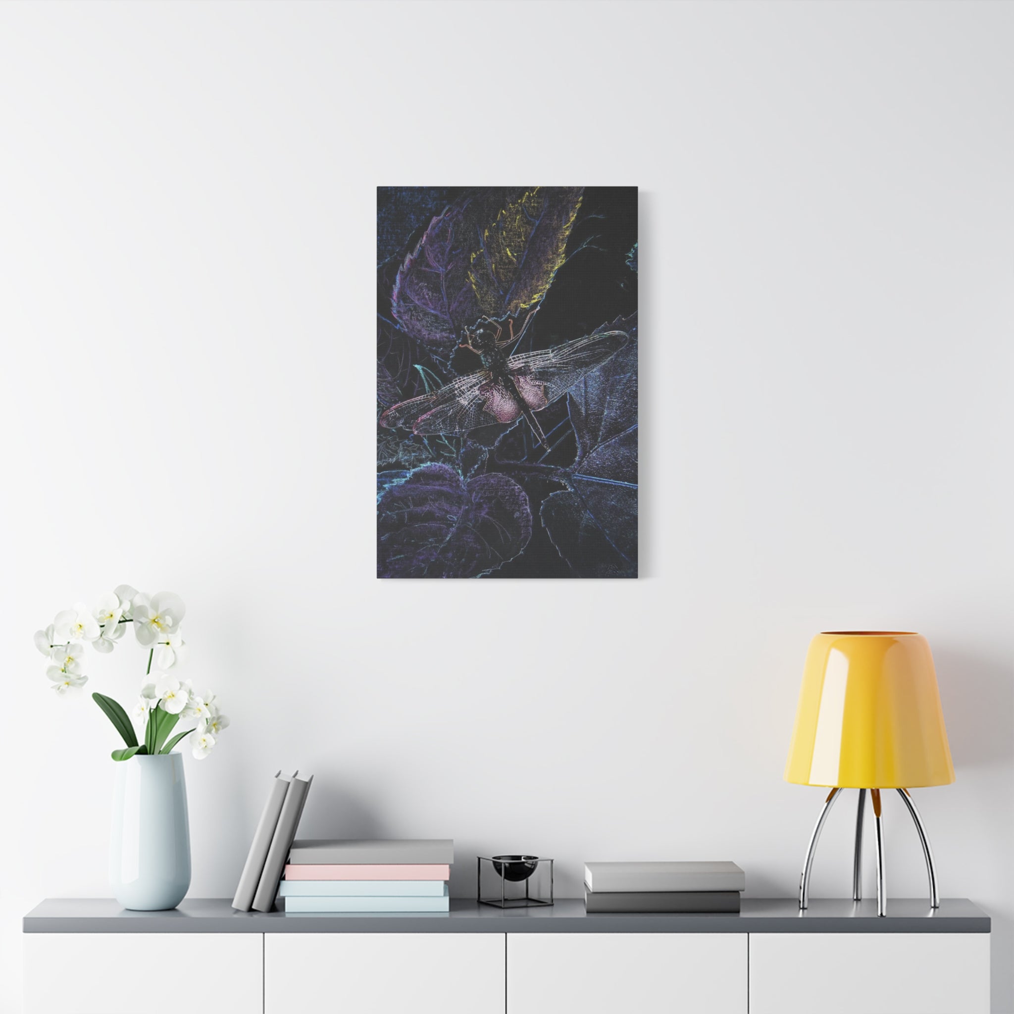 Abstract artwork of a dragonfly on a white wall above a shelf with decor items.