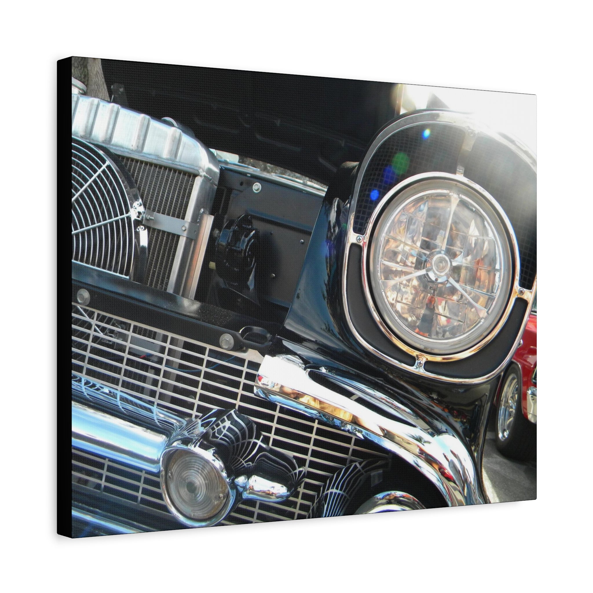 Close-up of a classic car's front grille and headlight on a white background