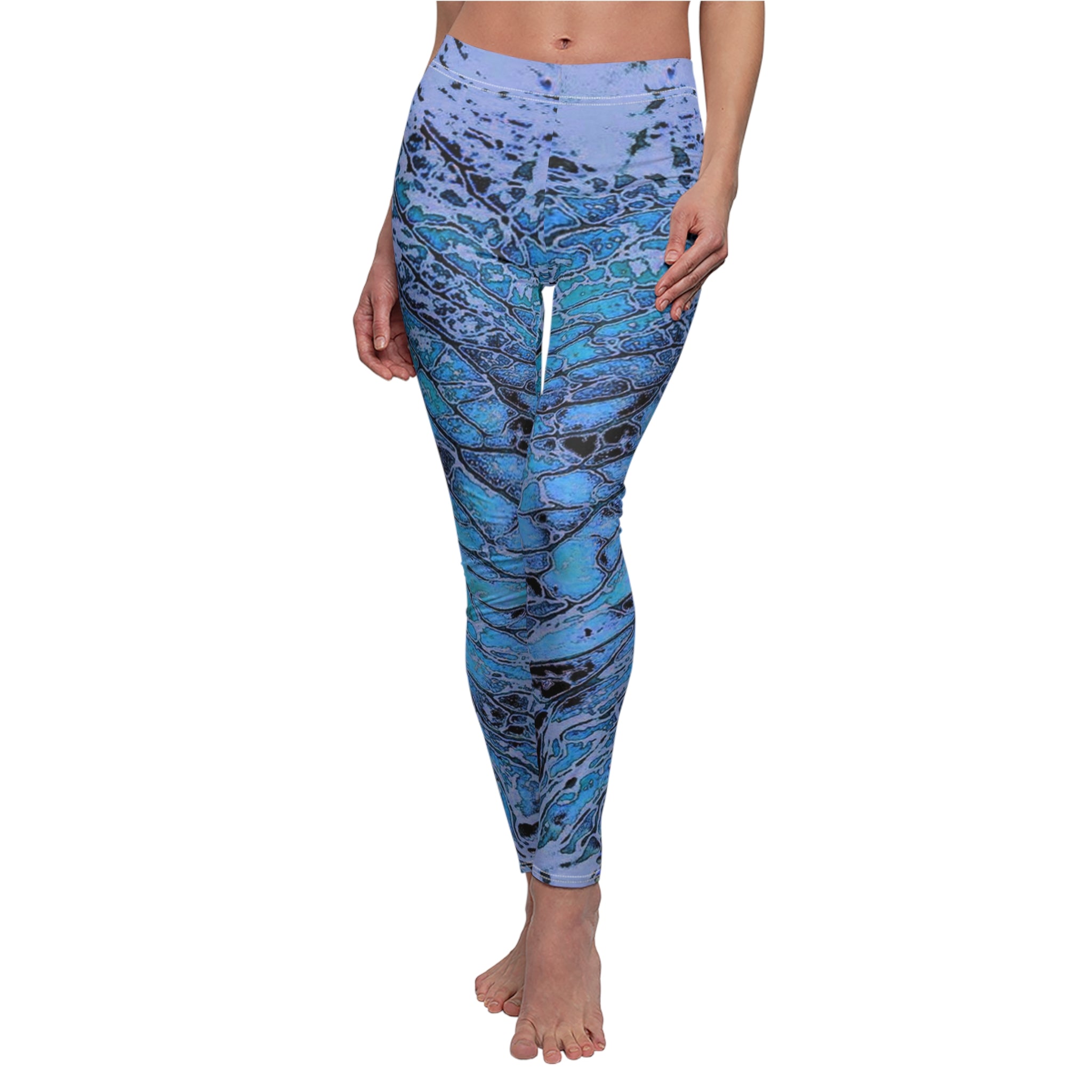 Blue and black patterned leggings worn by a person on a white background
