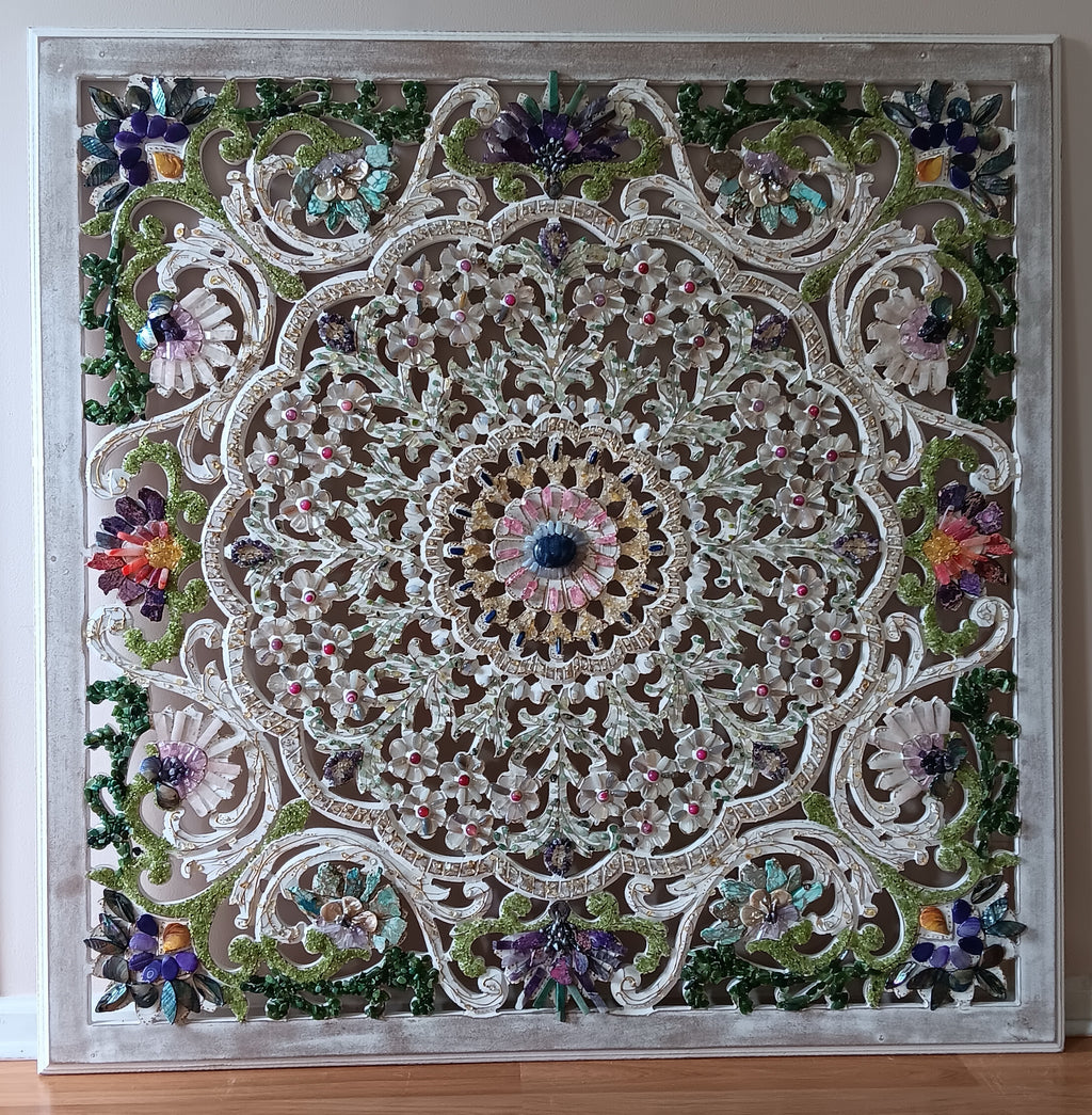 Decorative wall art with a floral mandala design on a wooden surface.