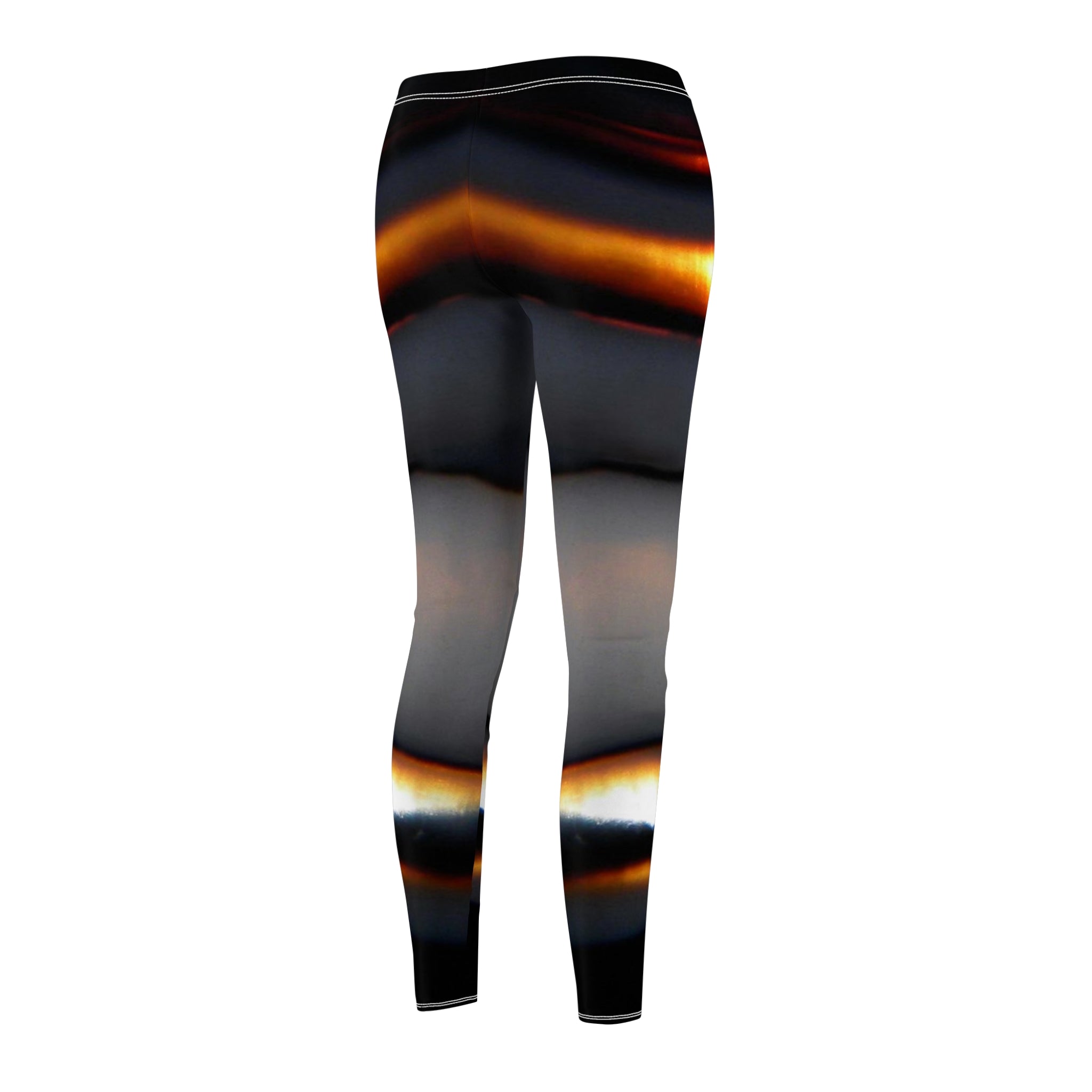 Leggings with a black, orange, and gray abstract pattern on a white background