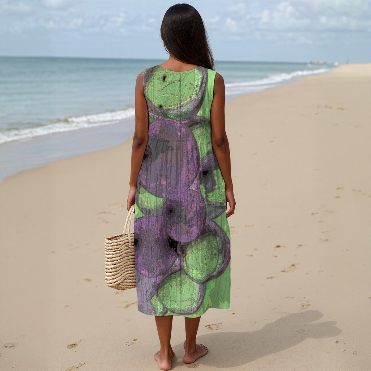 Woman in a green and purple dress standing on a beach