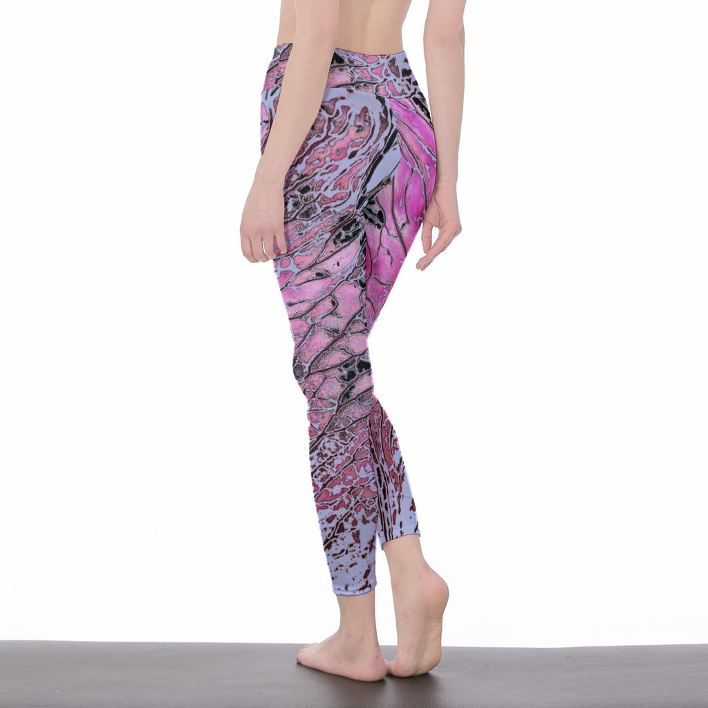 Person wearing pink and purple patterned leggings on a white background