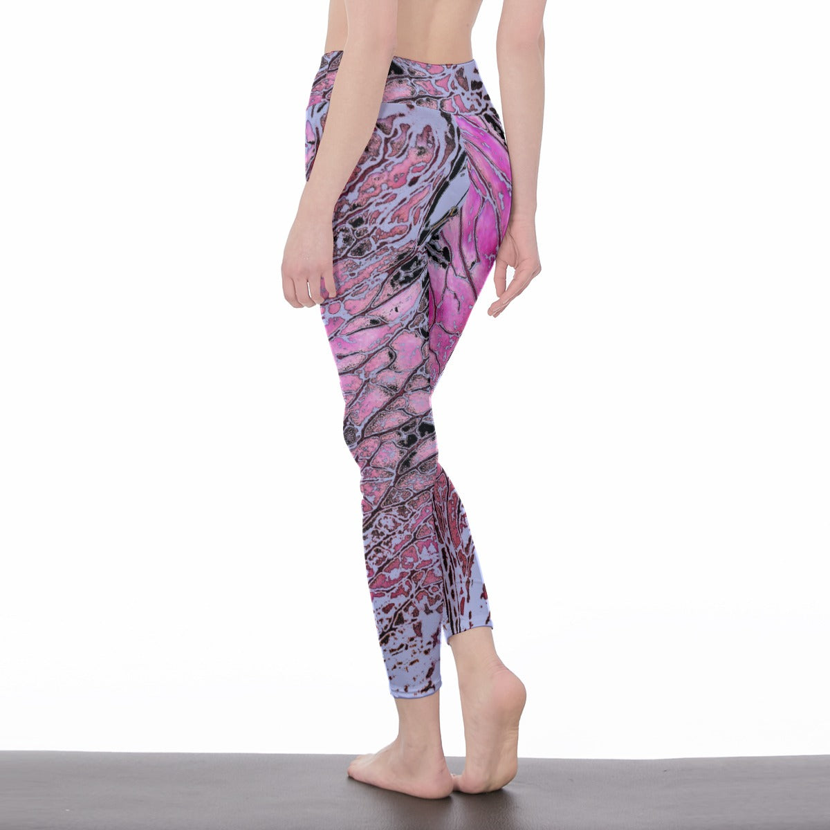 Person wearing pink and purple patterned leggings on a white background