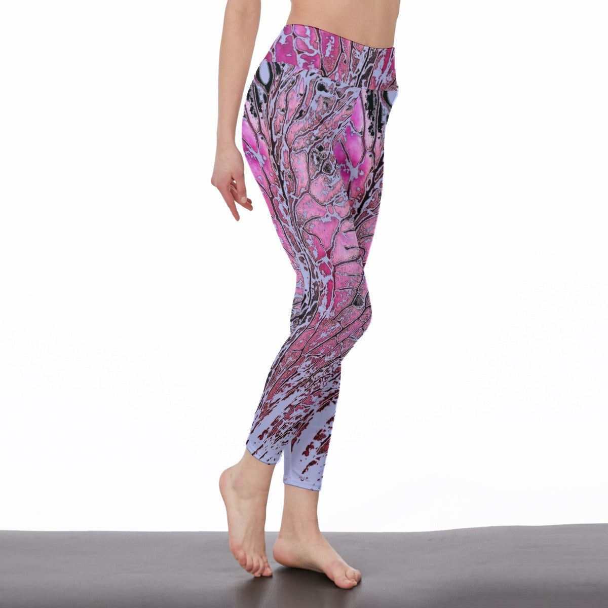 Person wearing pink and purple patterned leggings on a white background