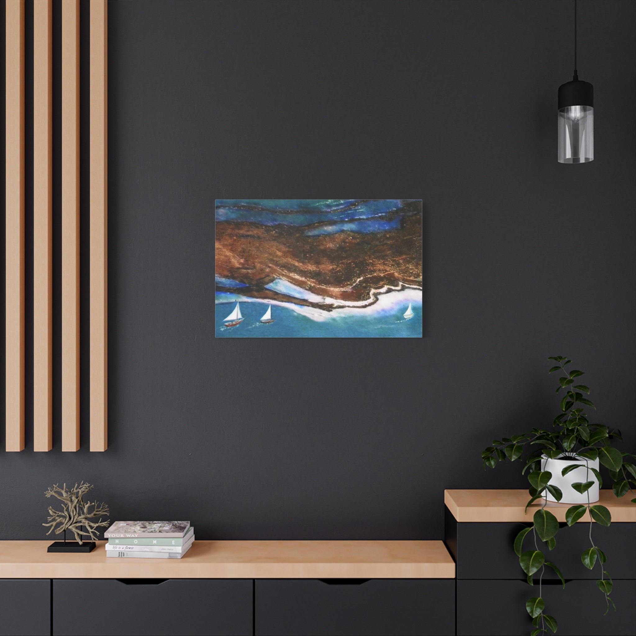 Framed artwork of a coastal scene with sailboats on a dark wall above a wooden console table.