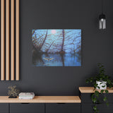 Canvas print of a bird flying over water with tree reflections at dusk.