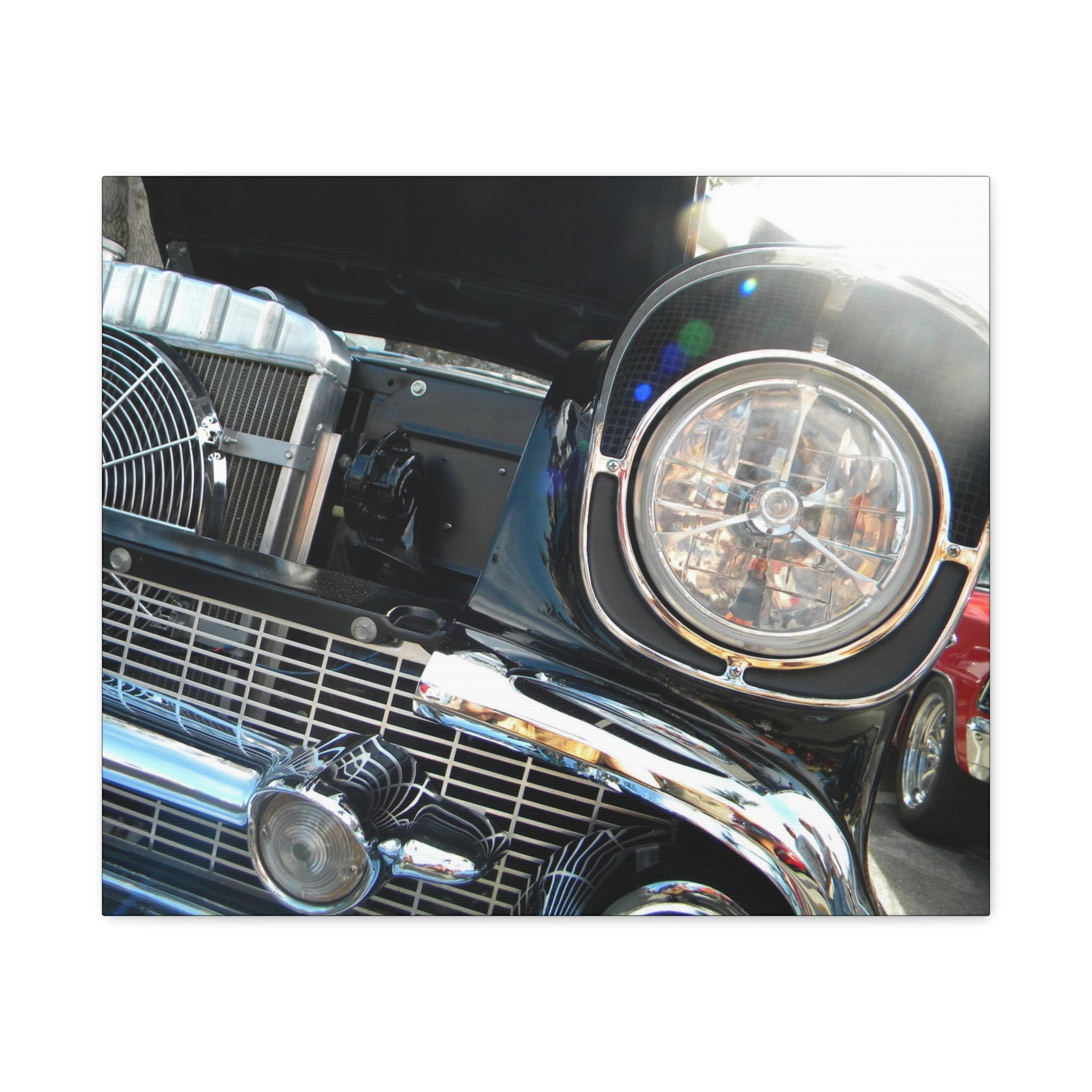 Close-up of a vintage car's front grille and headlight