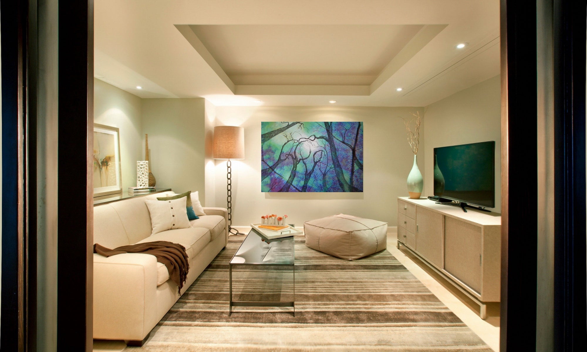 Modern living room with a couch, coffee table, and painting on the wall
