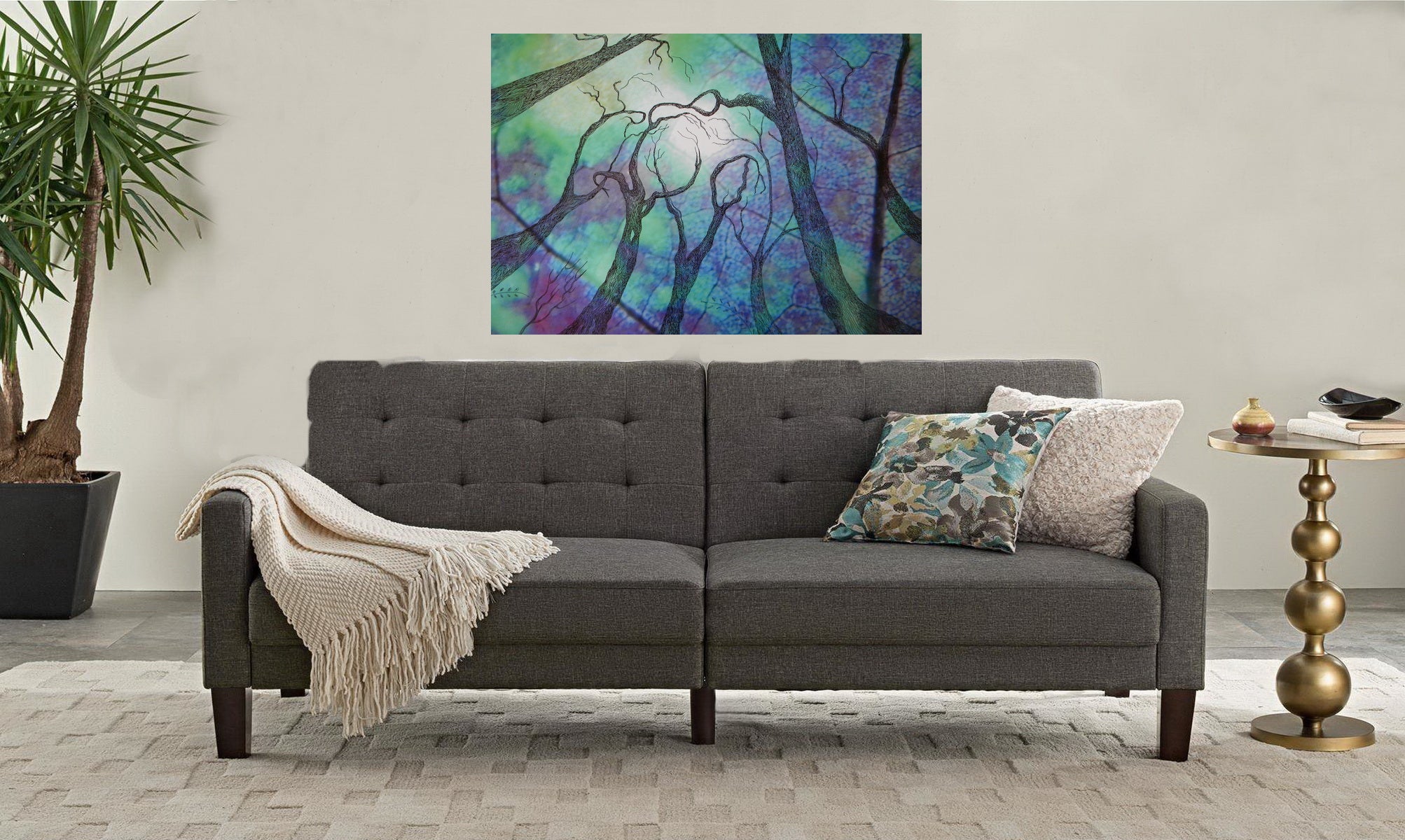 Gray sectional sofa in a living room with a colorful abstract painting on the wall.
