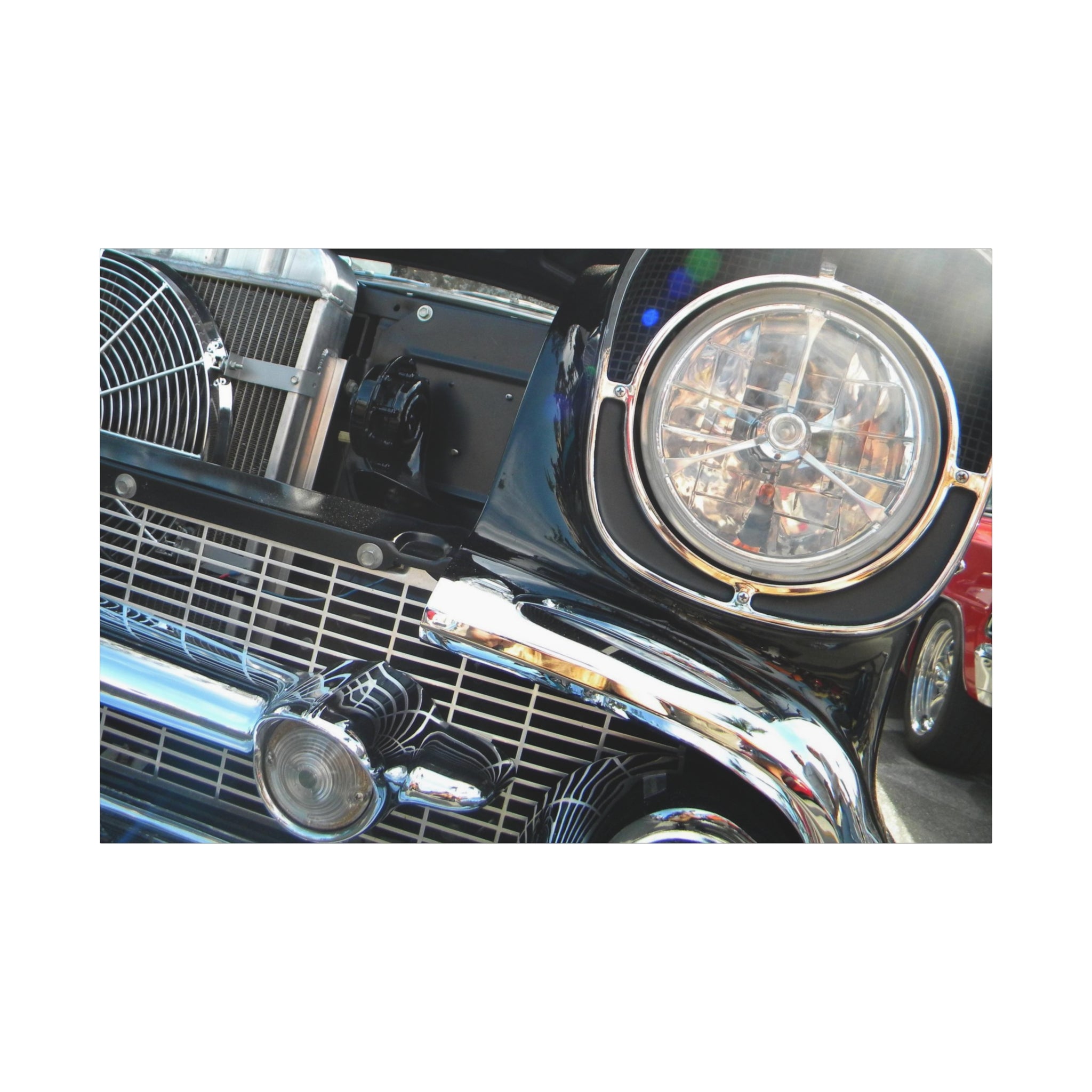 Close-up of a vintage car's front grille and headlight