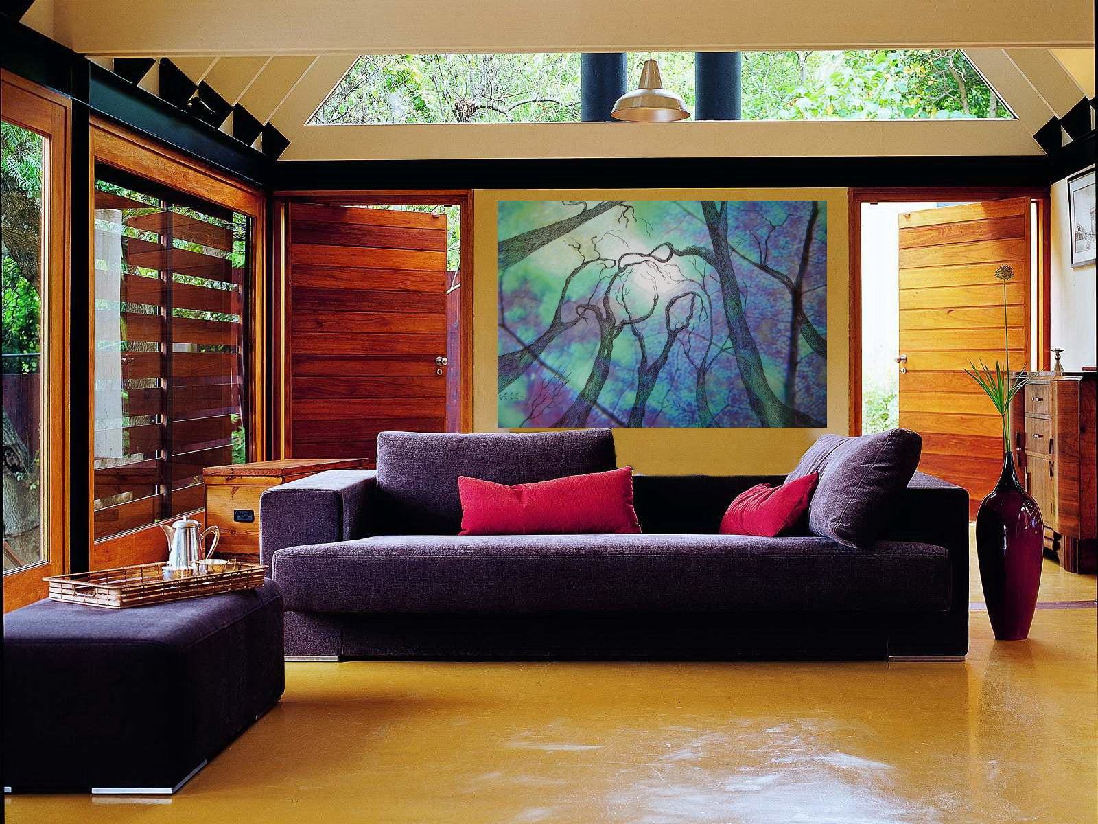 Modern living room with a purple sofa, red pillows, and a colorful abstract painting on the wall.