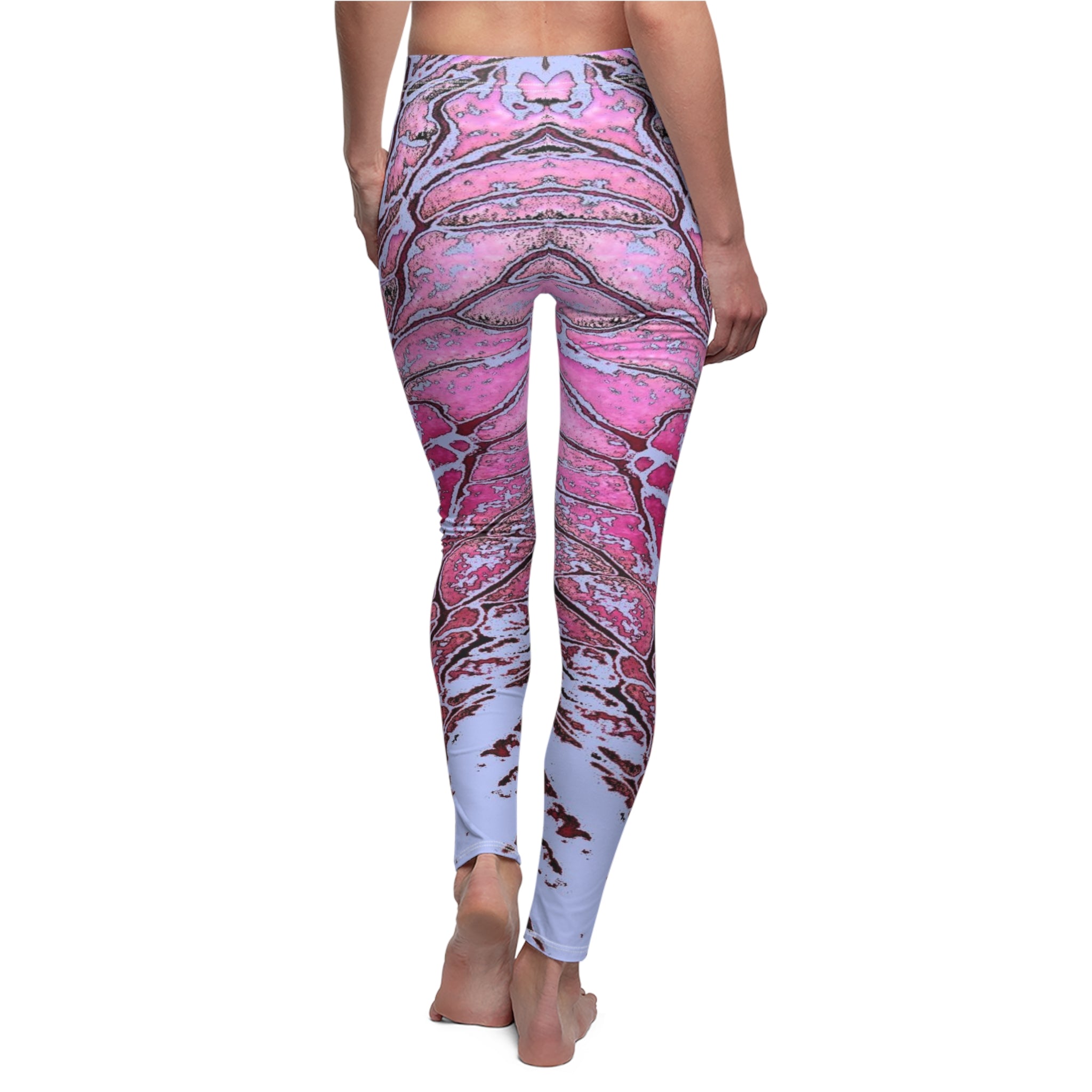Pink and white patterned leggings worn by a person on a white background