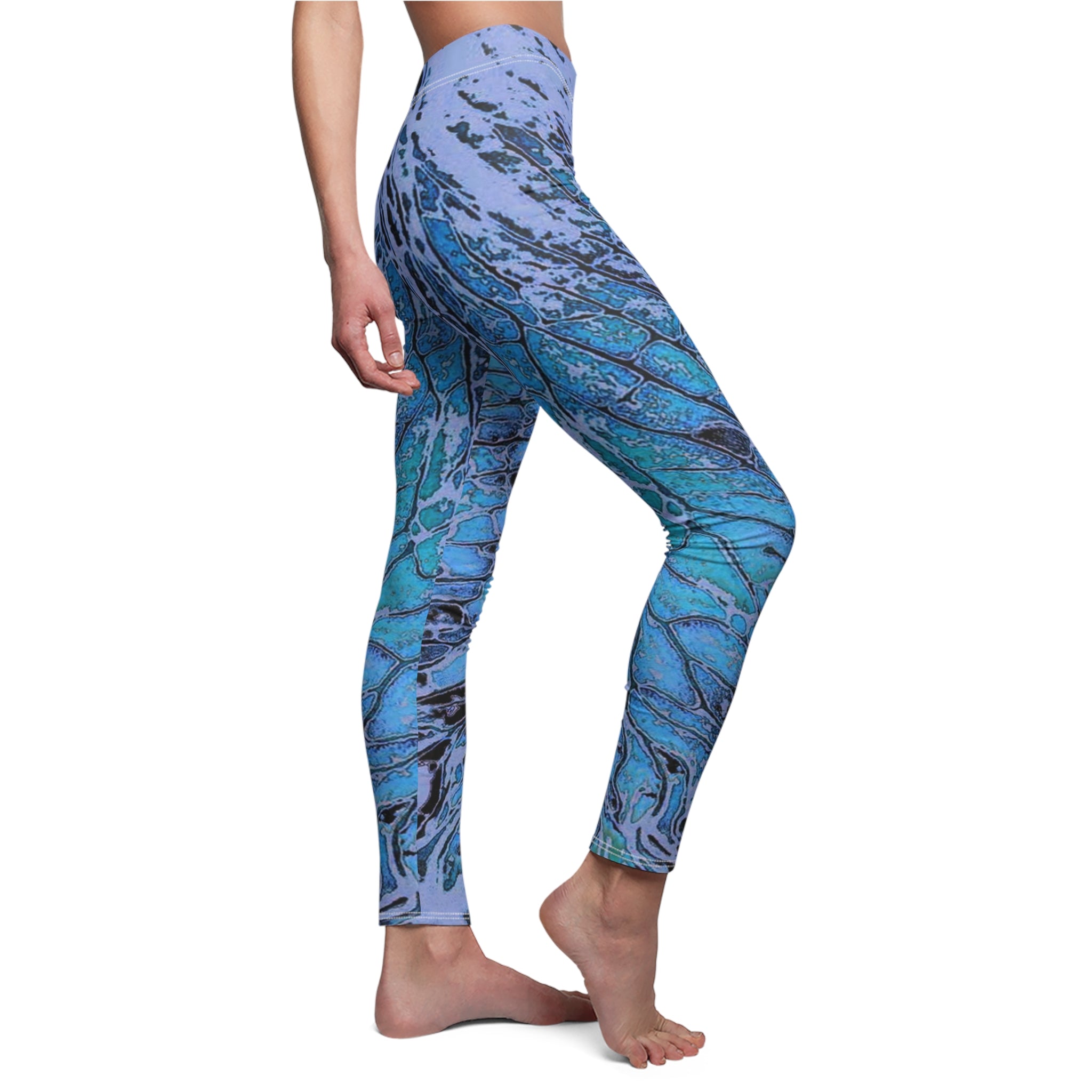 Blue and purple patterned leggings worn by a person on a white background