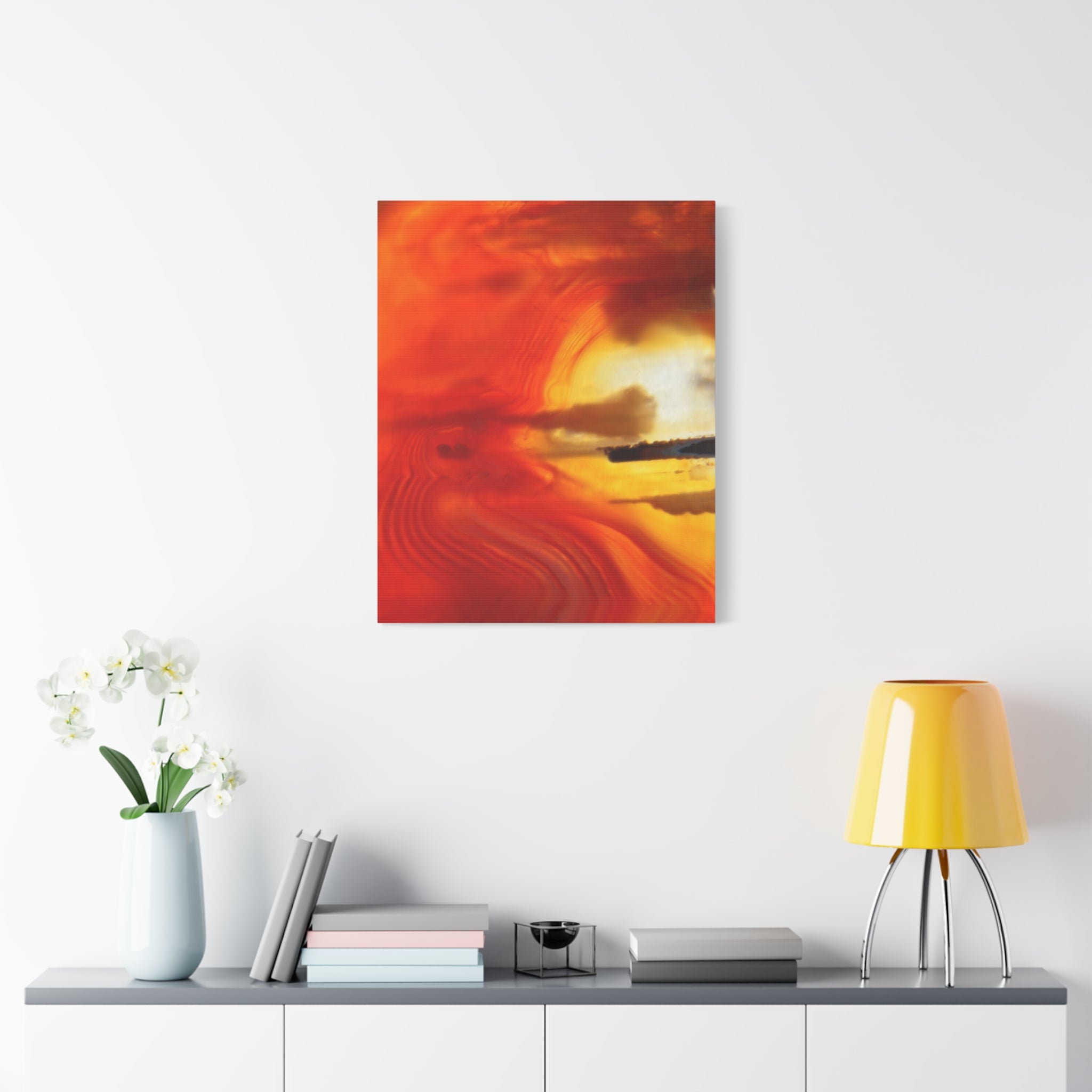 Abstract painting with warm colors on a white wall above a shelf with decor items.