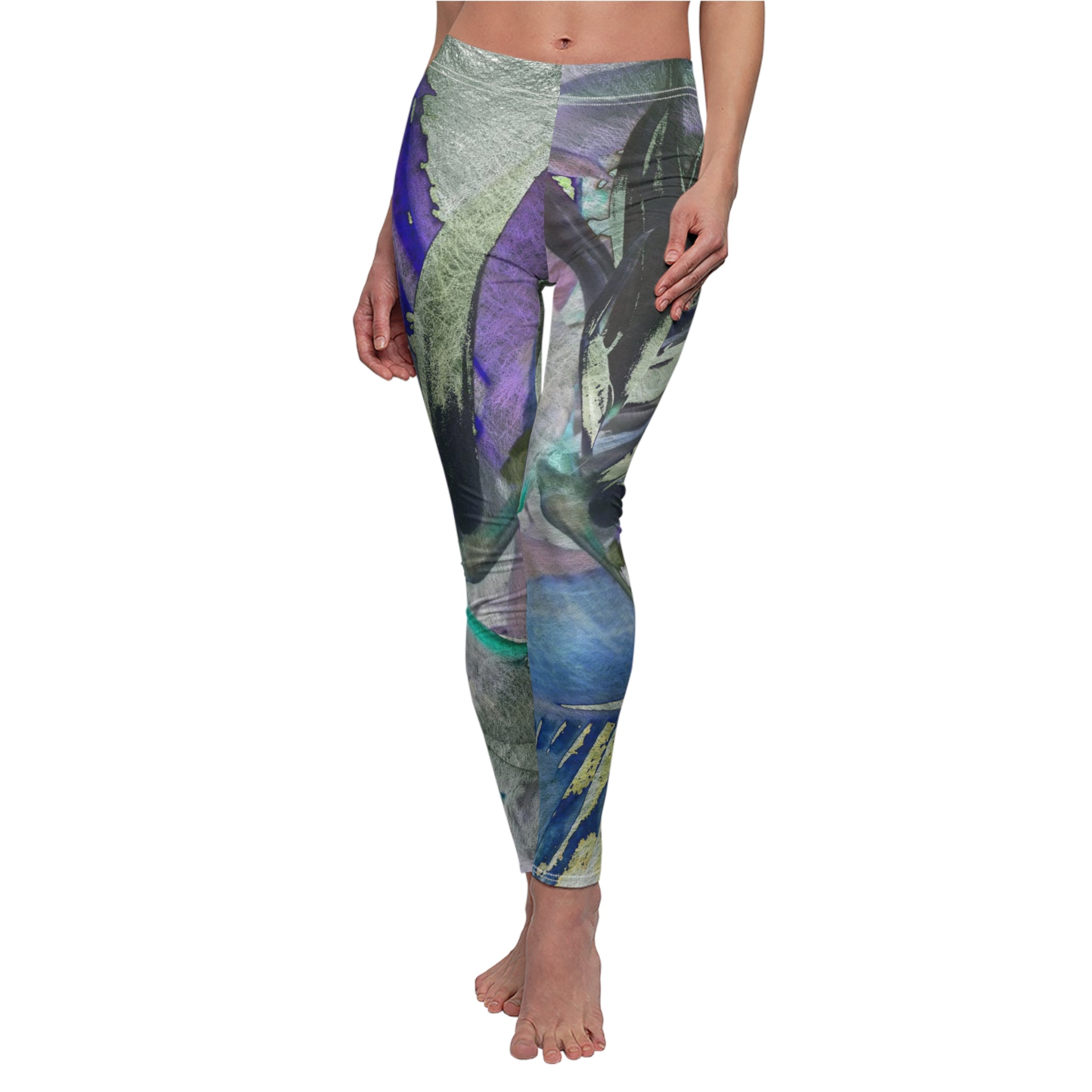 Leggings with a colorful leaf pattern worn by a person on a white background
