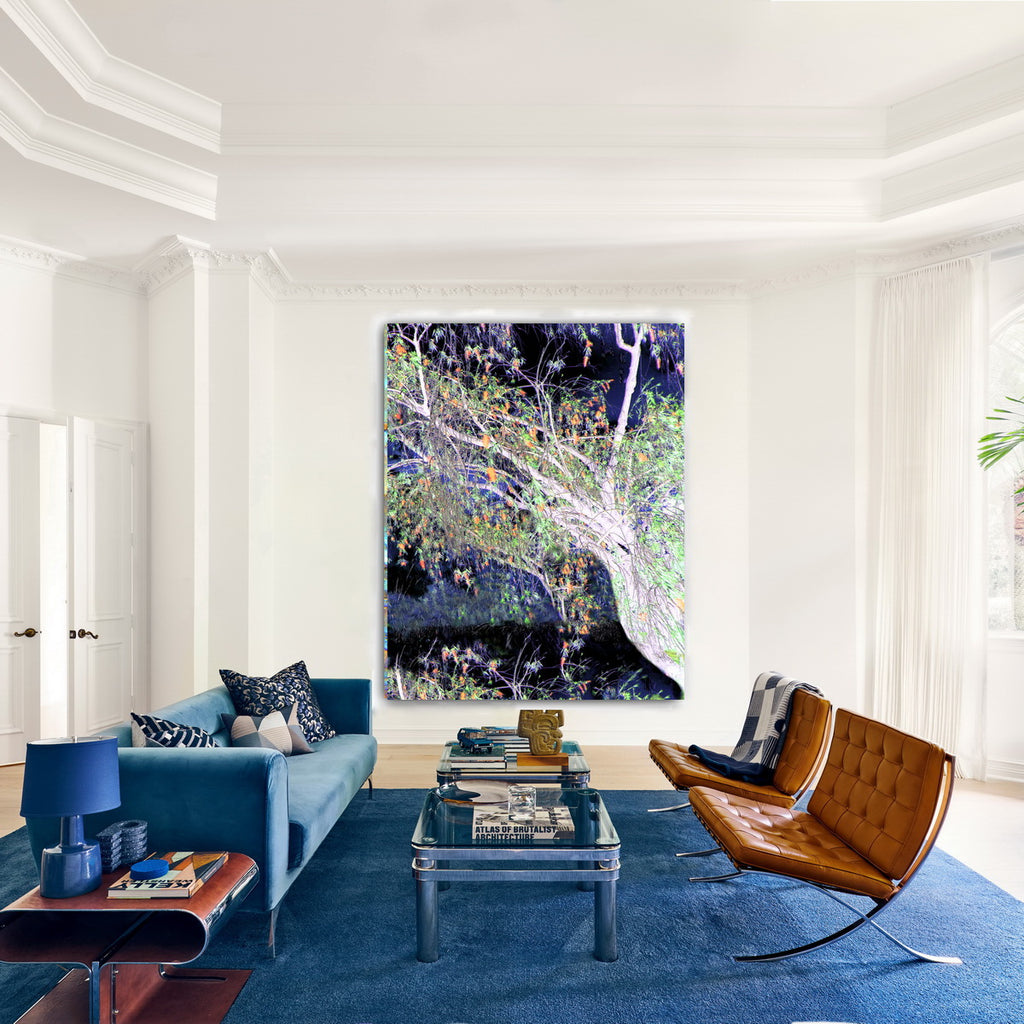 Modern living room with blue sofa, brown chair, and large abstract painting on white wall.