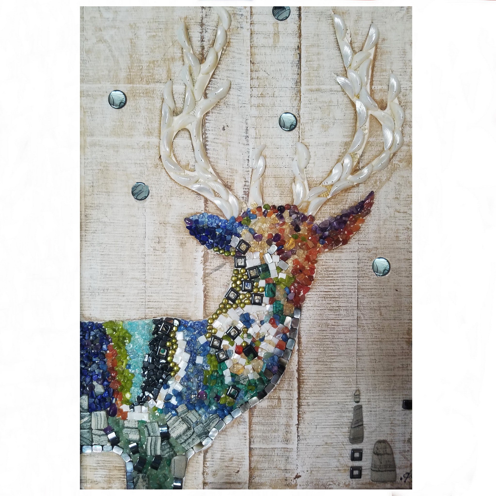 Decorative wall art of a deer with multicolored mosaic body on a wooden background