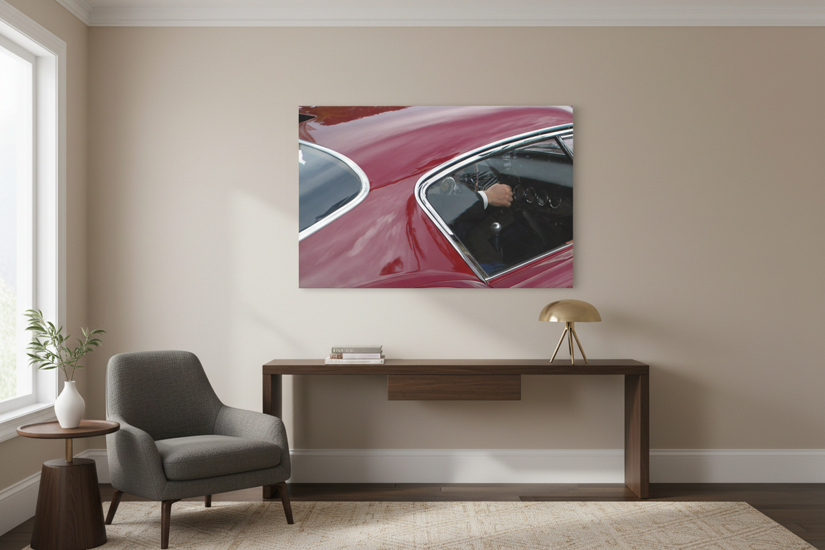 Vintage red car canvas displayed on a beige wall in a sophisticated study