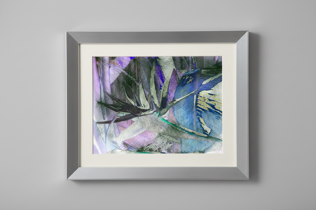 Tropical leaf artwork in wider silver frame