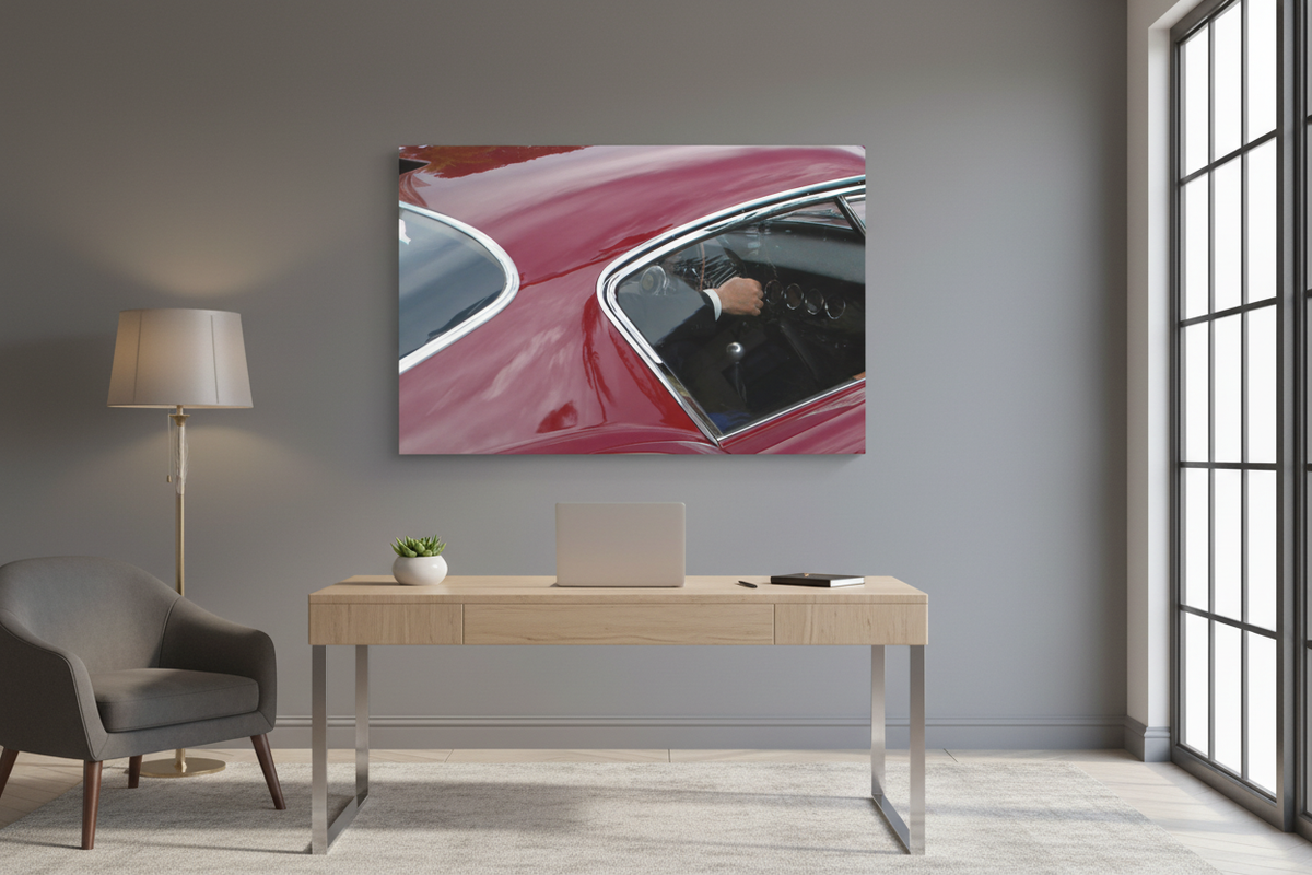 Vintage red car canvas displayed on a gray wall in a modern office