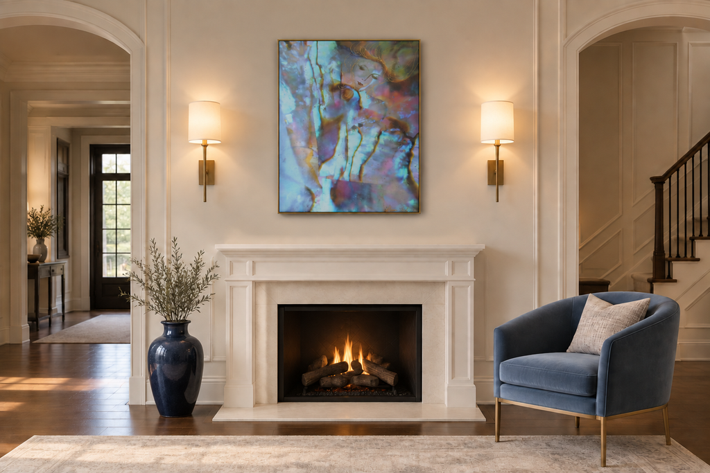 Ala Picasso canvas displayed slightly smaller above a white fireplace between two lights with a blue chair and dark blue vase