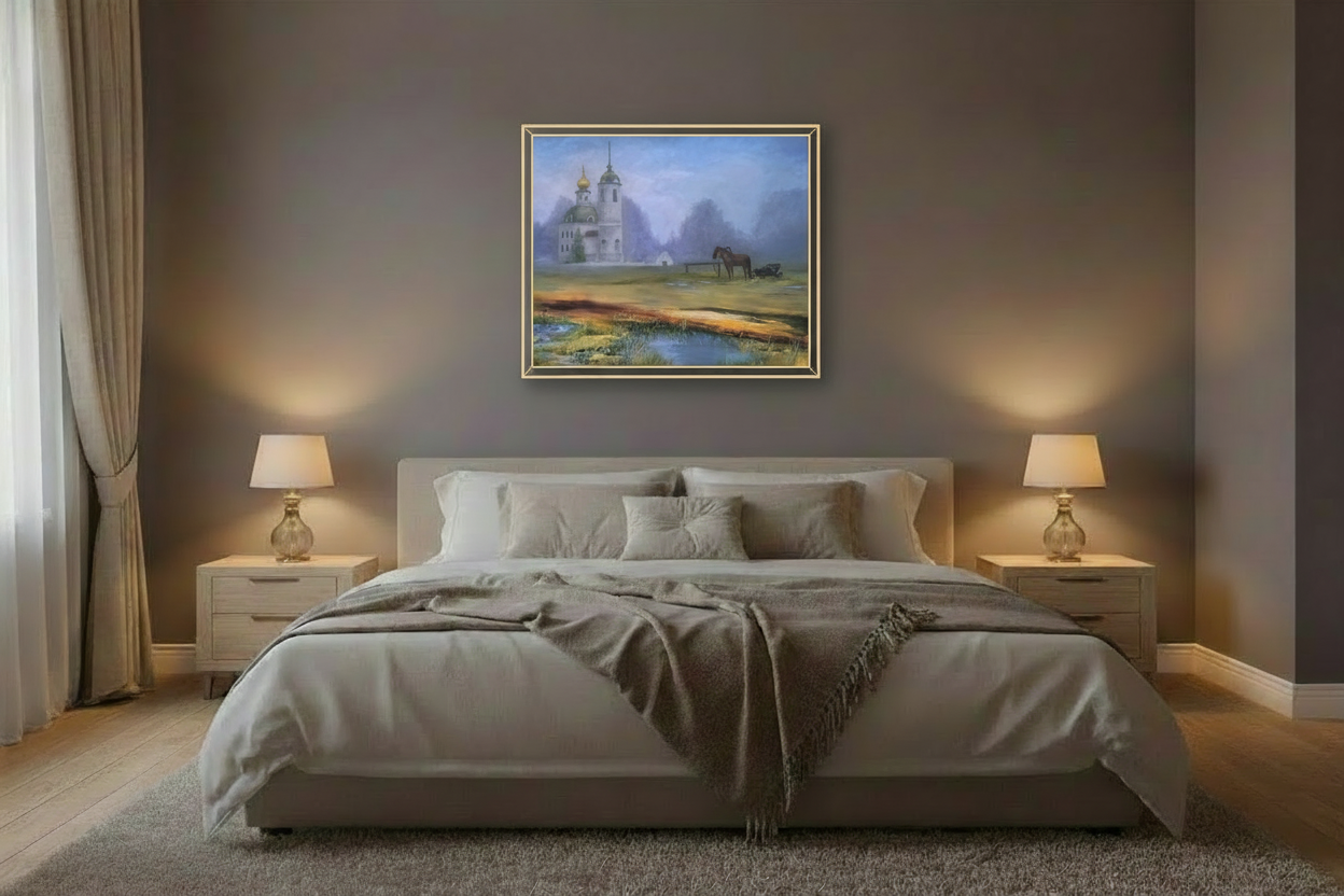 Artwork in thin light gold frame displayed in bedroom with warm low lighting